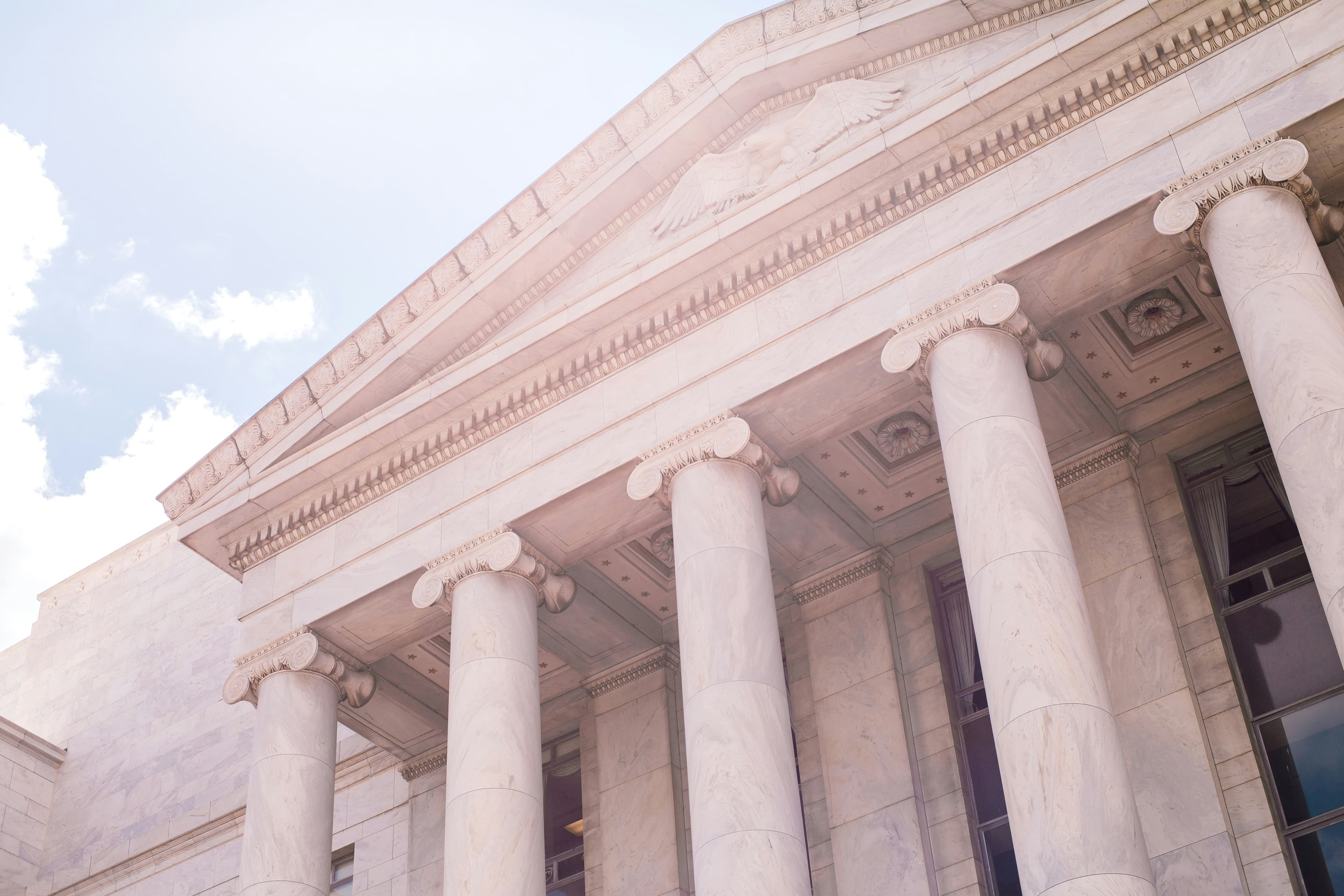 Picture of a marble white Government Building with large windows