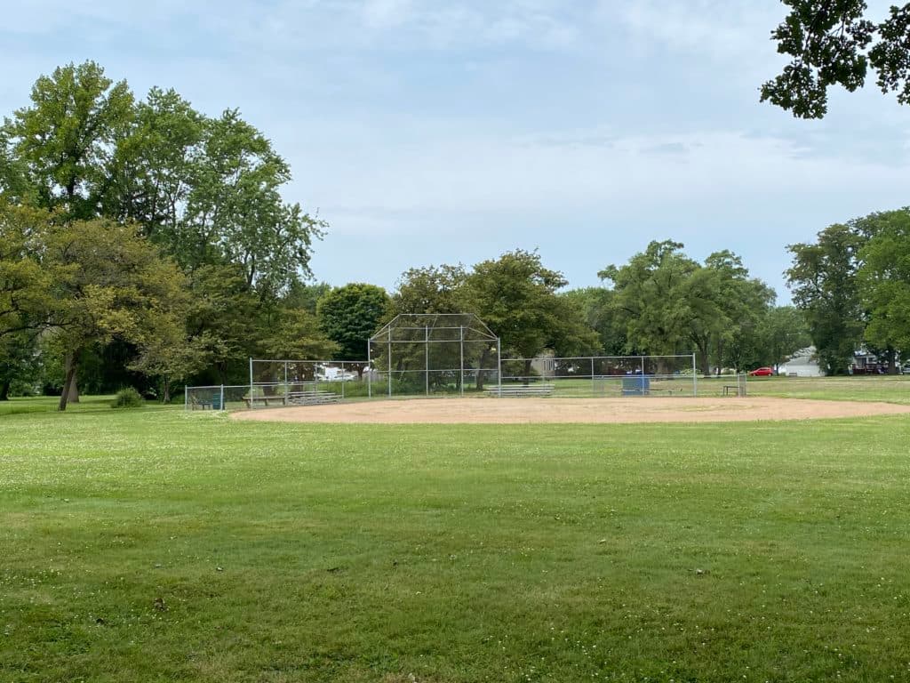 Baseball field at Van O Park in South Holland, Illinois, with backstop and open grassy area.